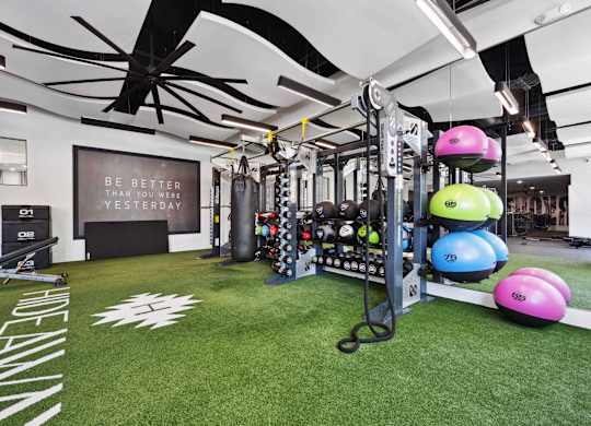 A gym with a green floor and a sign that says