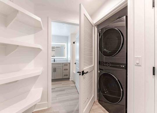 a laundry room with a closet and a washer and dryer
