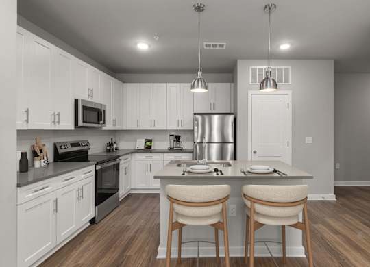 A modern kitchen with white cabinets and a wooden island.