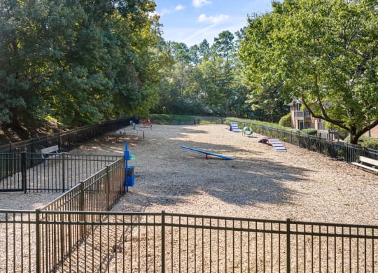 a playground in a park with benches and trees at View at Lake Lynn, Raleigh, 27613
