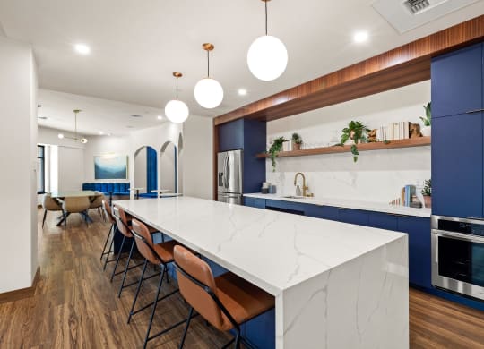a large kitchen with blue cabinets and a white counter top