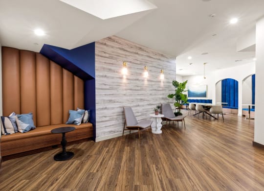 a living room with wooden floors and a blue accent wall