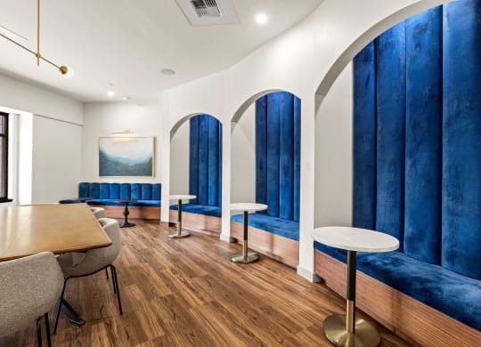 a dining room with blue booths and tables