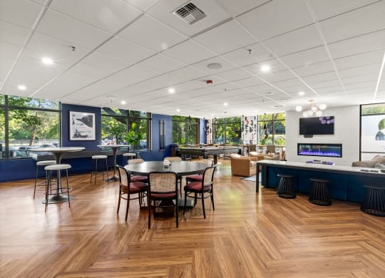 a dining room with tables and chairs and a bar with a television