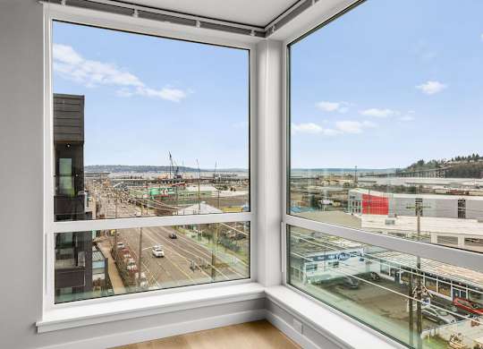 A view from a window looking out at a cityscape.