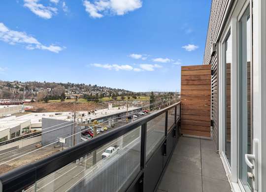 A balcony with a view of a highway and buildings.
