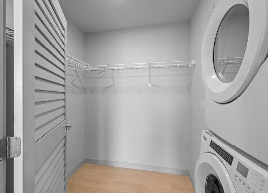 A washing machine is in a small laundry room.