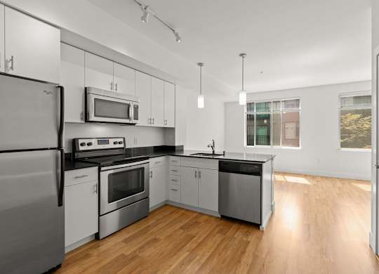 Modern kitchen with stainless steel appliances at Six Oaks Apartments, Bothell, 98011
