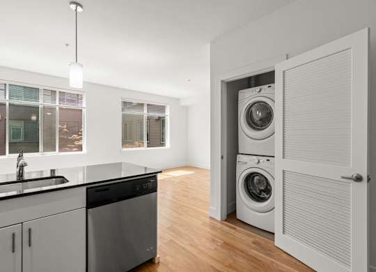 Inunit washer and dryer with bifold doors at Six Oaks Apartments, Bothell