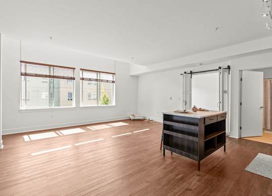 Spacious room with island and barn door at Six Oaks Apartments, Bothell, WA 98011