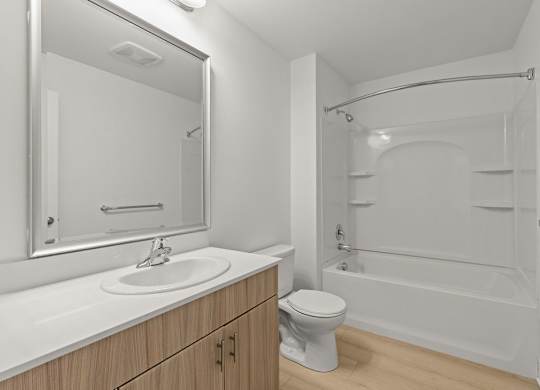 Bathroom with soaking tub and builtin shelving at Six Oaks Apartments, Bothell