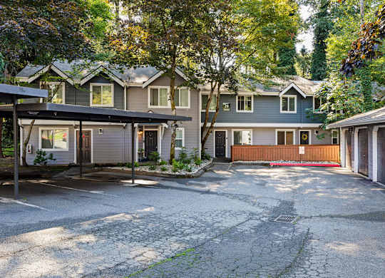 Two story townhome building with covered parking at Hidden River Townhomes Apartments, Kirkland, 98034