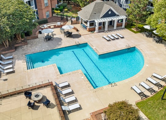 an overhead view of a swimming pool and patio with chairs at Mariners Crossing, Raleigh, 27613