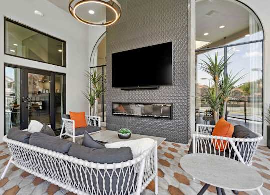 A modern living room with a fireplace and a television.