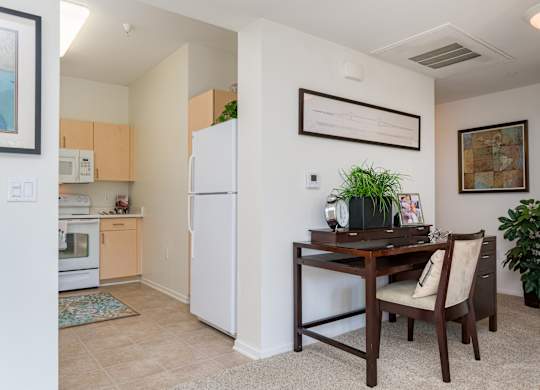 A kitchen with a table and chairs in the middle of the room.