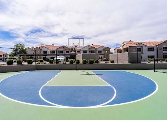 A basketball court in the middle of a housing complex.