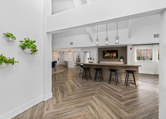 a living room with a fireplace and a table with bar stools