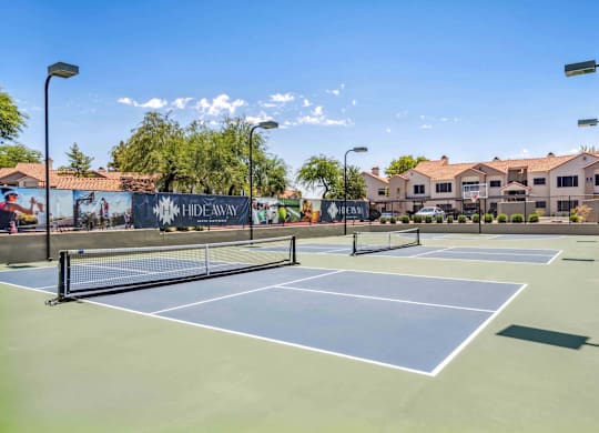 A tennis court with a sign that says