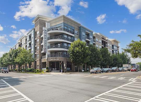 a large apartment building with balconies and a sign on the side of the building that reads