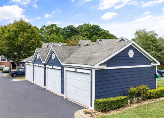 a blue and white garage with a brick building behind it at Mariners Crossing, Raleigh North Carolina 