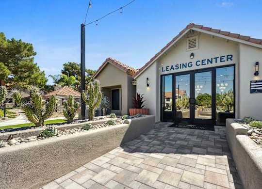 A leasing center with a brick walkway leading to the entrance.