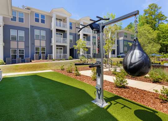 A playground with a swing set in front of apartment buildings.