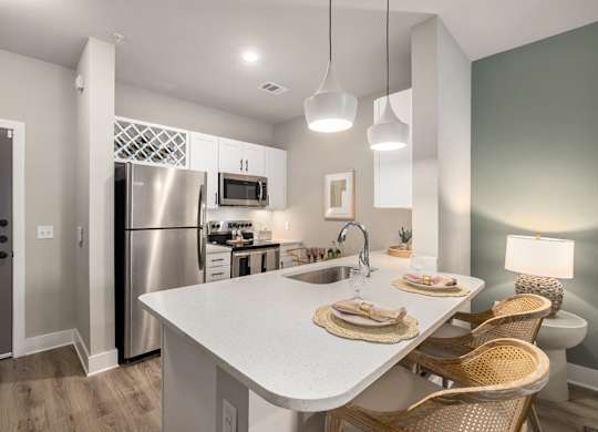 a kitchen with stainless steel appliances and a white counter top