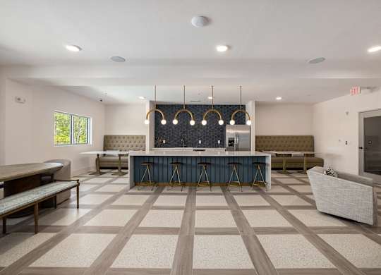 a clubhouse with a bar and seating area with chairs and a table