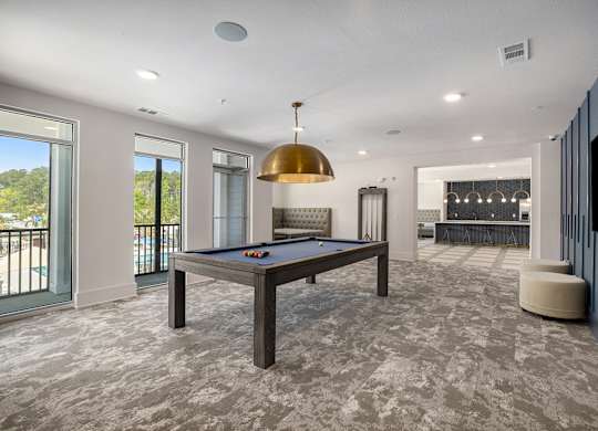 a game room with a pool table and a bar