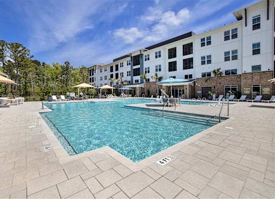 a swimming pool with a building in the background