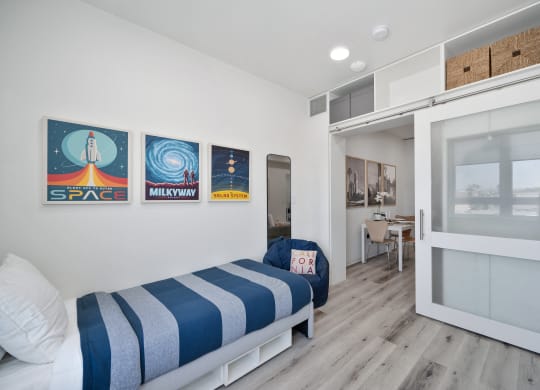 a bedroom with a bunk bed and a door to a bathroom