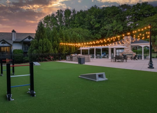 a backyard with a baseball field and a patio with lights