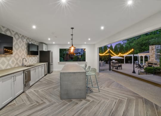 a large kitchen with a bar and a table with chairs