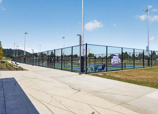 A black fence surrounds a playground.