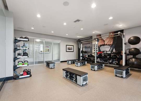 A gym with a variety of equipment including weights and machines.