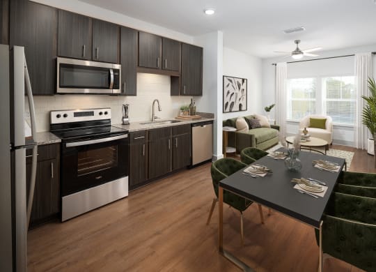 a kitchen and living room with a table and chairs