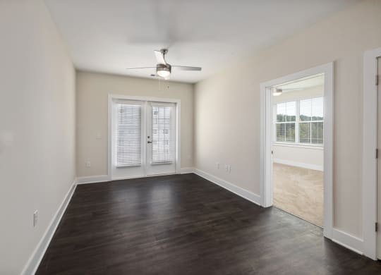 Living area with a ceiling fan and patio door