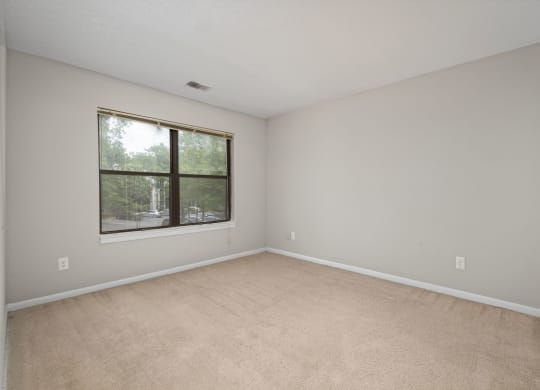 an empty living room with a large window
