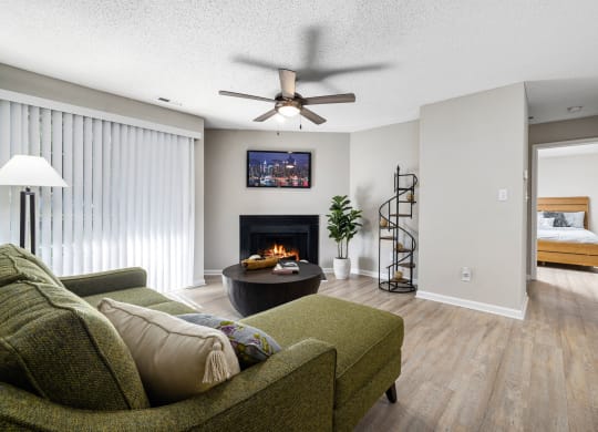 a living room with a couch and a fireplace at View at Lake Lynn, Raleigh, 27613