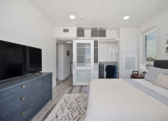 a bedroom with a large bed and a tv