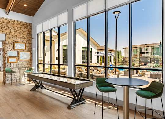 Great room with shuffle board and large windows