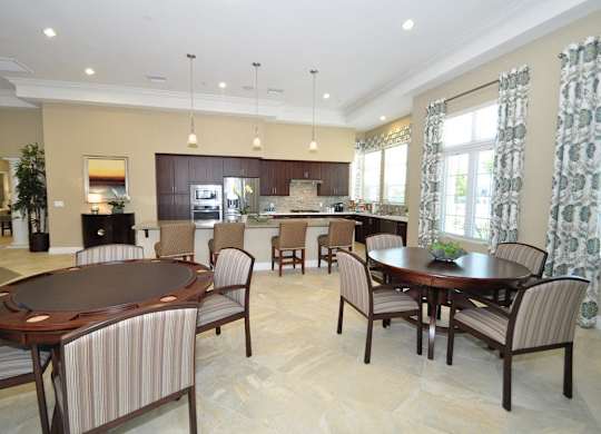 A large dining room with a round table and chairs.