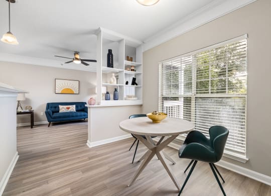 a dining room with a table and chairs and a large window at Mariners Crossing, Raleigh, 27613