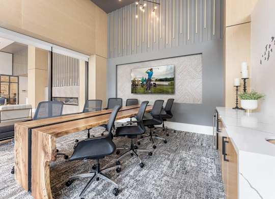 A conference room with a long table and chairs.