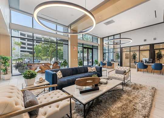 A modern living room with a large window and a variety of seating options.