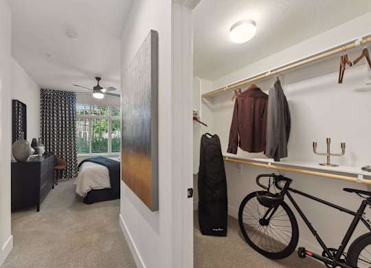 A bedroom with a bicycle in the corner.