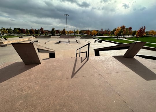 Skate park with ramps and a pole.