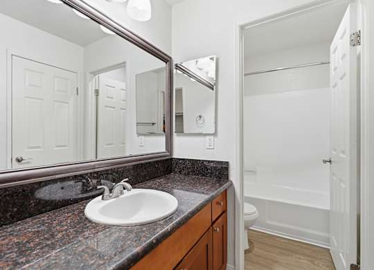 A bathroom with a sink and mirror.