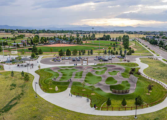 A park with a playground and a walking path.