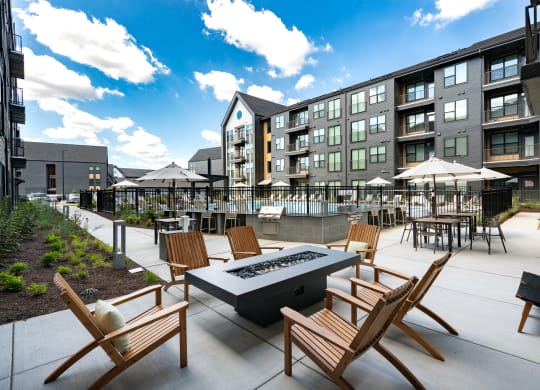 an outdoor patio with chairs and a fire pit